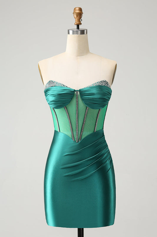 Robe moulante de cocktail avec corsage bustier et perles, vert foncé pailleté