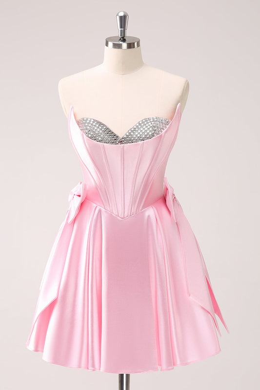 Robe de bal bustier rose ornĂ©e de perles avec nĆuds