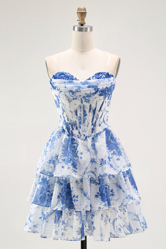 Robe de cocktail bustier blanche à fleurs bleues, coupe trapèze et volants étagés