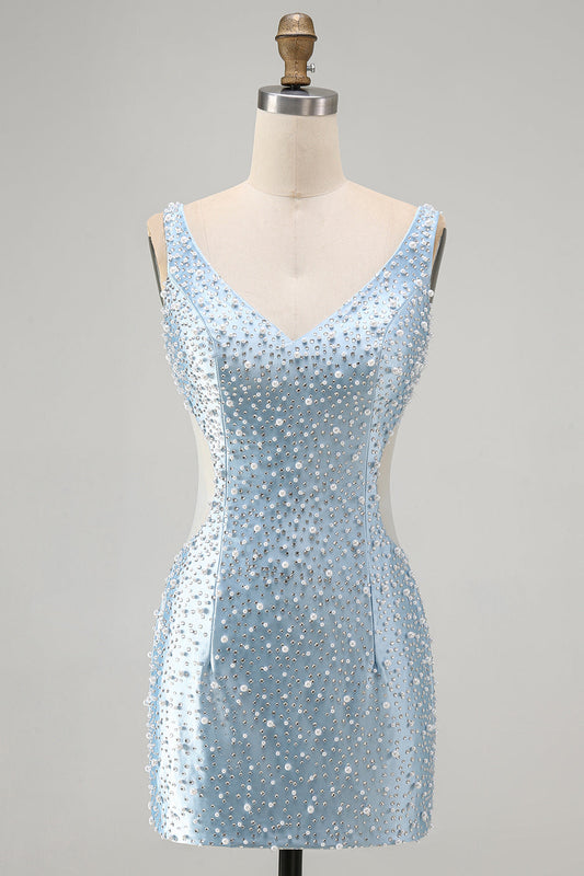 Robe courte de retour au bercail moulante bleue avec corsage bustier, décolleté en V, découpes et perles