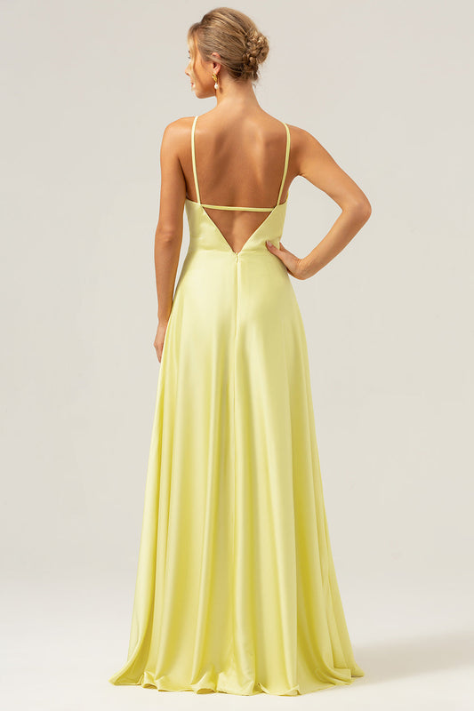 Robe de demoiselle d'honneur longue jaune trapèze dos nu avec découpes et fleur