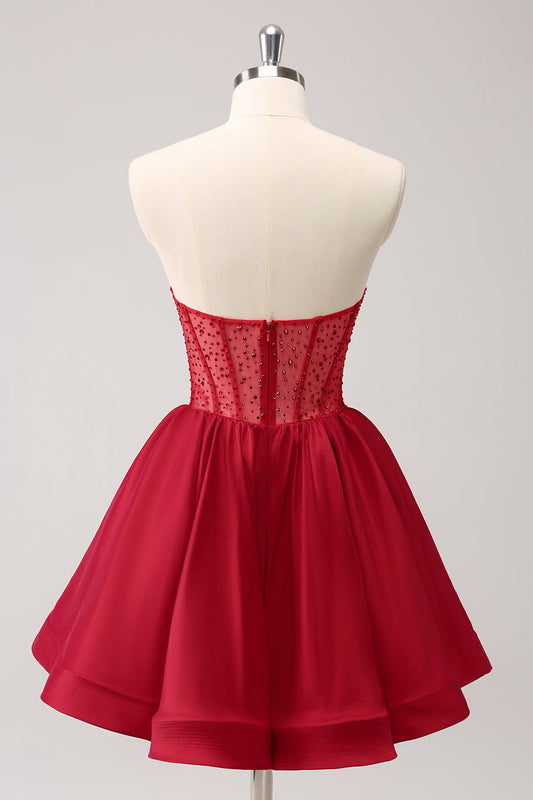Jolie robe de bal courte évasée rouge bustier avec volants et perles