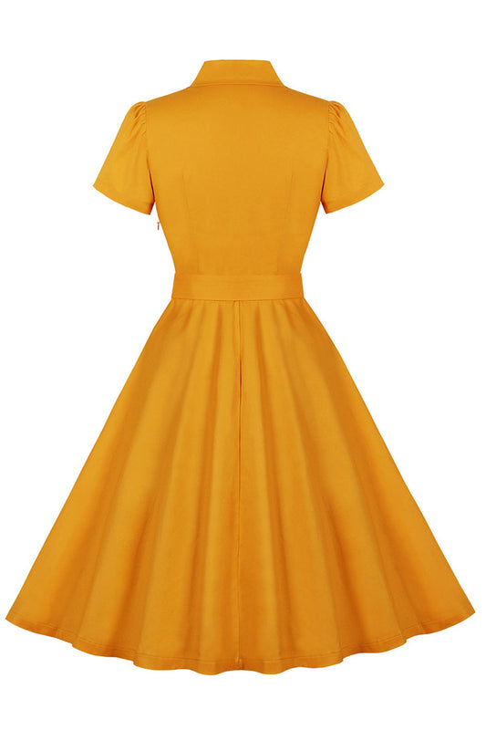 Robe jaune à revers crantés, ceinture à nœuds, style années 50, avec poches