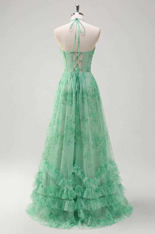 Robe de bal longue verte trapèze, dos nu, corset fleuri, volants, fendue