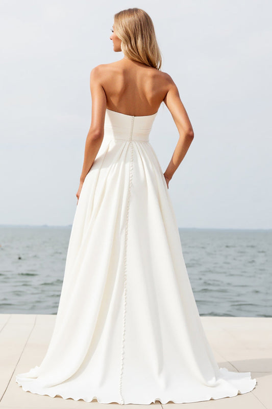 Robe de mariée bustier évasée en mousseline couleur ivoire avec fente, idéale pour la plage