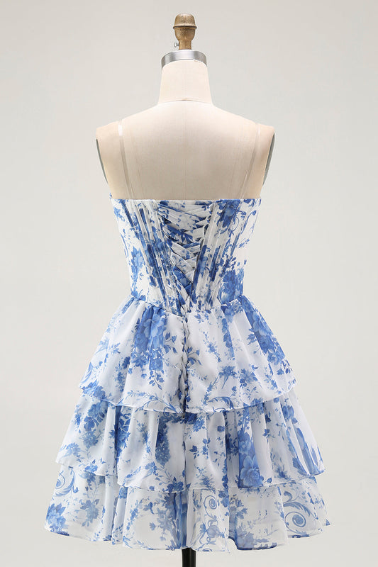 Robe de cocktail bustier blanche à fleurs bleues, coupe trapèze et volants étagés