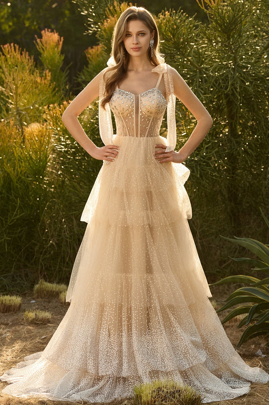 Robe de bal longue en champagne avec corset, coupe trapèze, volants et perles, dos lacé