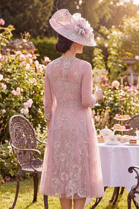 Robe de mariée mi-longue en tulle rose poudré à col rond brodée de perles