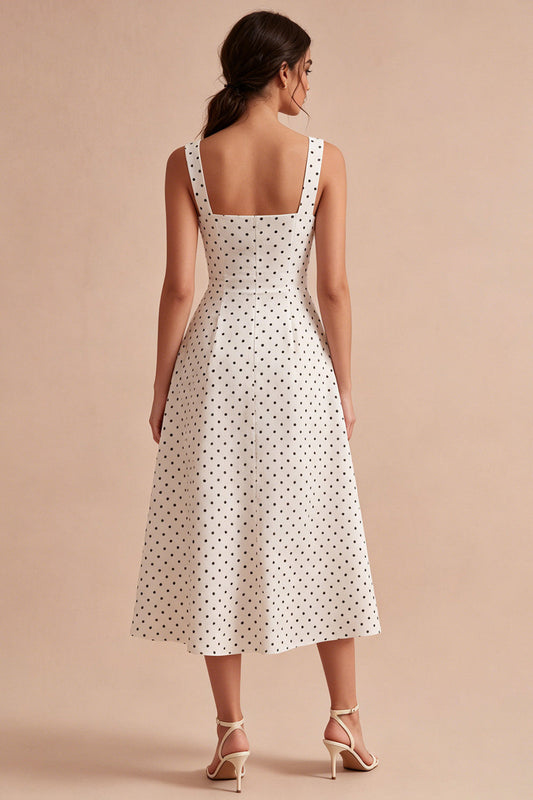 Robe mi-longue évasée à pois, avec de larges bretelles noires et blanches