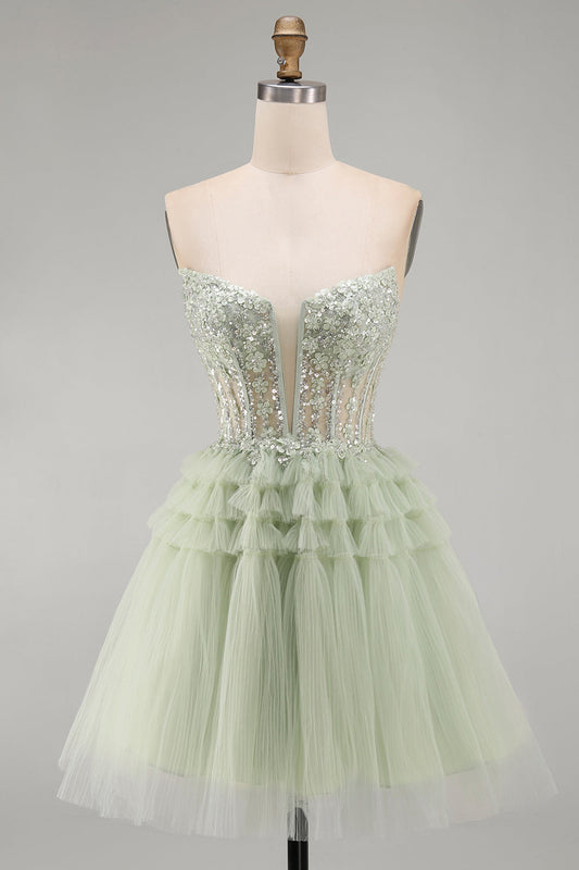 Robe de bal bustier coupe trapèze vert sauge avec corset, fleurs, volants et perles