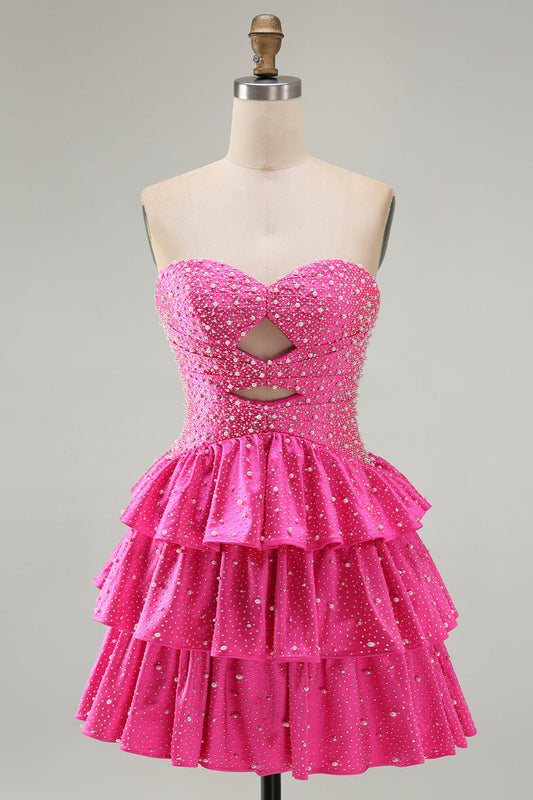 Robe de bal fuchsia à volants étagés, ornée de perles, avec découpes et coupe trapèze perlée